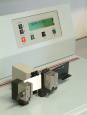 The crease stiffness test being performed with a machine.