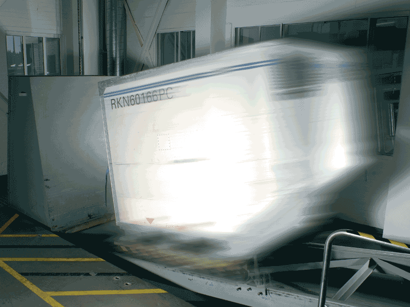 A large package in an impact test being moved at high speed into a wall.